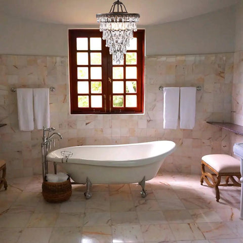 Crystal Chandelier in Farmhouse Bronze, 4 Light Hanging Pendant Fixture above elegant bathroom with bathtub.