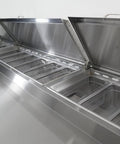 No Nonsense Heavy Duty Commercial Prep Table Refrigerator With Extra Wide Stainless Steel Worktop And Massive Cold Storage For Pizza And Sandwich Professionals, open stainless steel lids revealing storage bins.
