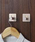 Heavy Duty Aluminum Alloy Wall Hooks With Peel And Stick Adhesive for Zero Drill Hassle, sleek brushed finish on wood.