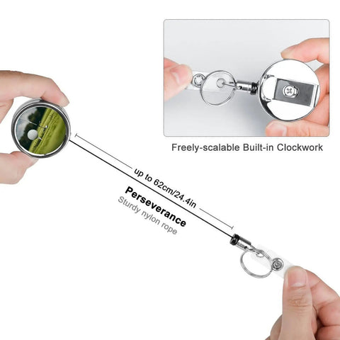 Heavy Duty Metal Badge Reel With 360 Degree Swivel And Secure Belt Clip shown pulled out to 62cm, held by hand, reflective stainless steel.