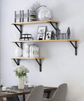 Floating shelves supported by Heavy Duty 10 Inch L Shelf Brackets 6 Pack White Triangular 90 Degree Metal Supports with decorations.