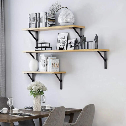 Floating shelves supported by Heavy Duty 10 Inch L Shelf Brackets 6 Pack White Triangular 90 Degree Metal Supports with decorations.