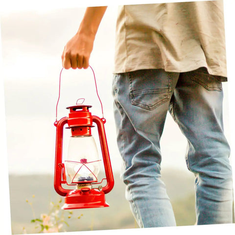 Person holding red kerosene lantern for outdoor use, suitable with 10 Piece Cotton Wick Set For Oil Lamps Kerosene And Propane Lanterns Gas