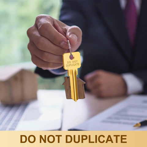 Bulk 50 Pcs Do Not Duplicate Metal Key Blanks For House Door Locks Gold SC4 Replacement Keys held by hand