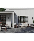 Modern outdoor seating area with 6-Inch Outdoor LED Cylinder Wall Sconce 2-Light Up And Down Mount, black, on white walls