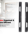 Two black mounting brackets from the Beefy Underbody Truck Tool Box Mounting Bracket Kit with tool wall in the background.