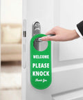 Person holding door with Durable PU Leather Do Not Disturb And Please Knock Door Knob Privacy Sign, green side visible