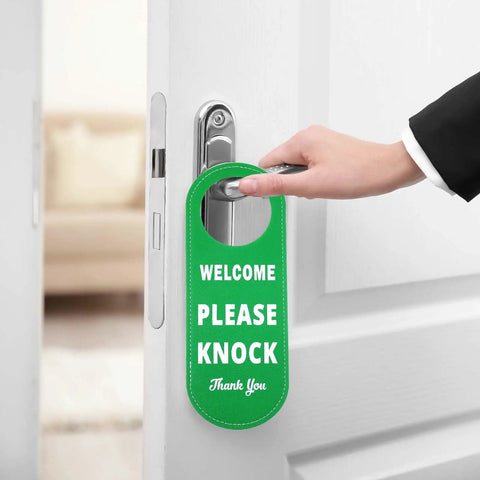 Person holding door with Durable PU Leather Do Not Disturb And Please Knock Door Knob Privacy Sign, green side visible
