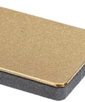 Close-up of DC4 Diamond Ceramic Whetstone Sharpener for Knives, pocket sized, with gold and gray finish, wet or dry use.