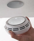 Installing smoke alarm with No Drilling Magnetic Smoke Alarm Mounts 3 Pack With Adhesive Pads for quick mess free ceiling install.