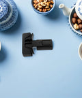 Kid Safe Refrigerator Locks 4 Pack No Tool Needed Quick Install Black ABS Material on a blue surface with tea set and nuts.