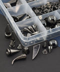 Badass Punk Spikes And Studs Kit 150 Piece Mixed Shape Gun Black Leather Rivets with various shapes in a clear container.