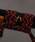 Close-up of a katana scabbard with black and red rope, showcasing 3.3 Yard Synthetic Silk Sageo Wrapping Cord For Katana Scabbard DIY Maintenance TopNotch Black High Quality Japanese Samurai Sword Saya Cord For Easy Wrapping And DIY Sword Care.