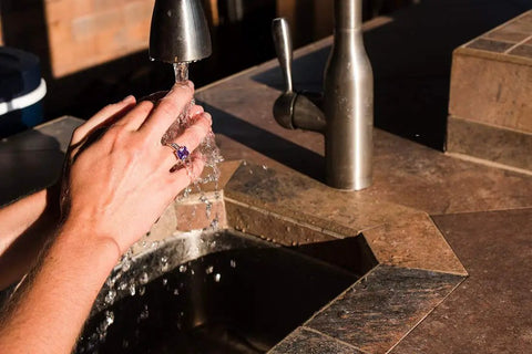 Person washing hands, wearing Invisible Ring Size Adjuster For Loose Rings With Six Sizes Keeps Your Engagement And Wedding Rings Snug And In Place No More Slips Clear Ring Band Sizer Guard For Loose Jewelry Multipack Ten Count.