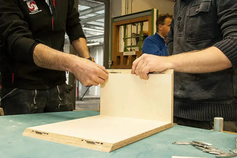 Two people assembling hardwood panel using Silver Biscuit Connector Set Size 20 Die Cast Wood Joiner For Invisible Joints