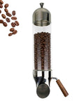 Wall Mounted Coffee Bean Storage Dispenser Crafted From Solid Airtight Stainless Steel And Glass Using Adjustable Output Gate To Lock In Daily Grind Freshness Multipurpose Canister For Cereal Candy Tea In Sleek Silver with coffee beans visible.