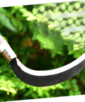 Close-up of manganese steel weeding hook from Durable Gardening Weeder Tool Set In 2 Pack against green leaves