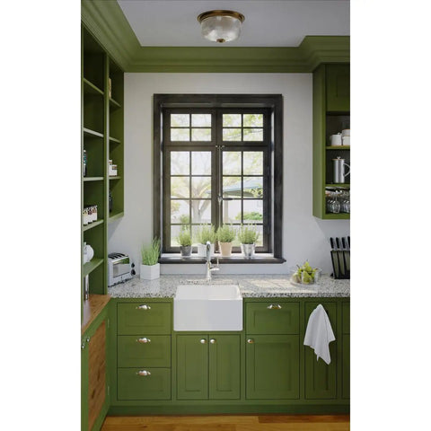 Kitchen with green cabinets and vintage brass two light close to ceiling flush mount fixture in Archie Collection style