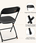 Back view of a black folding chair with ergonomic backrest, triangular supports, and leg protectors for Folding Chairs Sets Of 10 330 Lb Capacity Plastic Stackable Portable Patio Dining Set For Indoor Outdoor Use Camping Garden Party Meeting Black Weather Resistant For Year Round Use.