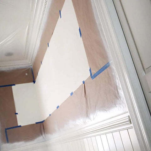 Room with walls protected by brown general purpose masking paper 12 in x 180 ft for painting trim, windows, and doors.