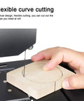 Desktop Woodworking Wire Saw With 800 Watt Motor And Hella Precise 1750 Rpm Speed For Smooth Straight Cuts And Top Notch Intricate Curves On Boards Or Bamboo Strips Up To 70 Millimeters Thick, cutting wood in a curved shape.