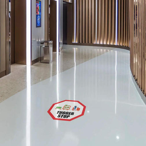 Stop That Tugger Now With These Heavy Duty Red Anti Slip Floor Decals Featuring Tough Round Vinyl Stickers For Warehouses And Factories To Boost Safety And Guide Forklifts Perfectly On Any Surface. Tugger Stop decal displayed on a glossy white surface.
