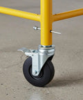 Tough As Nails 5 Inch Caster Wheels 4 Pack With Dual Locking Brakes For Heavy Liftin Jobs on yellow scaffold leg.