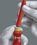 Hands attaching blade to Insulated Kraftform Kompakt VDE Blade Set With 60i 62i 65i 18, showing pro grade anti roll handle.