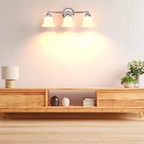 Dope Three Light Chrome Vanity Light Fixture With Frosted Glass Shades, mounted above wooden console in living room.