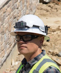 Worker wearing hard hat with Power Packed 3200 mAh USB C Portable Battery for cooling fans, safety gear on construction site