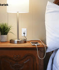 Durable White Duplex Outlet Covers 10 Pack Wall Plates For Outlets Dual Receptacle Faceplates in a bedroom with lamp and phone charger.