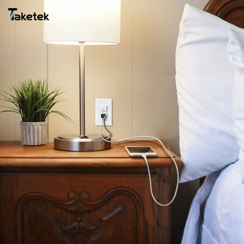 Durable White Duplex Outlet Covers 10 Pack Wall Plates For Outlets Dual Receptacle Faceplates in a bedroom with lamp and phone charger.