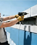 Man using a power tool to install Top Drawer One Hundred Pack Stainless Steel Blind Rivets on a construction site.