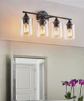 Four Light Matte Black Bath Vanity Light With Clear Glass Shades Industrial Farmhouse Sleek Modern Wall Sconce over mirror
