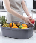 Must Have Cleaning Caddy Organizer With Handy Handle, Portable Shower Basket containing assorted fruits on kitchen counter