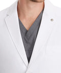 Close-up of Relaxed Fit Men's Lab Coat With 5 Pockets, Side Slits, Knit Details And 360 Degree Stretch For Easy Movement, White, 34.5 Inch Back Length, X Large on male model.