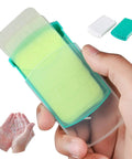 Close-up of On The Go Hand Soap Sheets For Travel And Outdoors in a green case, with lathered hands shown.