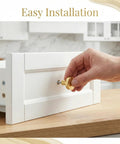 Installing 4 Pack Gold Solid Brass Round Drawer Knobs With Mounting Screws on a white cabinet
