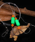 Surf Fishing Rigs For Pompano And Saltwater Gear with circle hooks and green floats on dark background