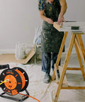 80 Ft Heavy Duty Retractable Extension Cord Reel With 4 Grounded Outlets, 13A Circuit Breaker in a workshop setting
