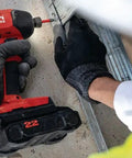 Worker using 22V Nuron SID 6 Cordless Brushless Impact Driver Tool Only With Quarter Inch Hex Quick Change on metal structure