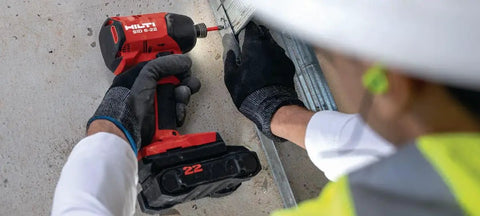 Worker using 22V Nuron SID 6 Cordless Brushless Impact Driver Tool Only With Quarter Inch Hex Quick Change on metal structure
