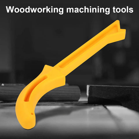 Safety Yellow Push Stick with No Slip Grip Handle for table saw woodworking, ABS build, resting on a woodworking table.