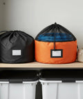 Heavy-Duty RV Water Hose Storage Bag With Secure Closure, Compact 7.9 X 7.1 Inch Organizer, orange and black, stored on shelf