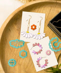 Hella Awesome Mini Flower Polymer Clay Cutters For Crafting Chic Daisy Rose Lotus Shapes With Top Shelf Hobby Molds on a wooden tray.