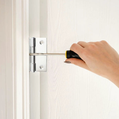 Installing Twenty Pack Heavy Duty Stainless Steel Folding Butt Hinges 2 Inch with screwdriver on wood.
