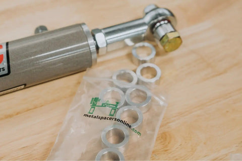Heavy Duty Aluminum Spacer Three Eighths Inch Outer Diameter And One Quarter Inch Inner Diameter Round Standoff Unthreaded Bushing Plain Finish For Quarter Inch Or M6 Bolts Half Inch Length Pack Of Ten shown next to a metal rod