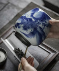 Solid Ceramic Tea Canister For Loose Leaf Storage being held with a spoon, showcasing its retro minimalist design and moisture proof lid.