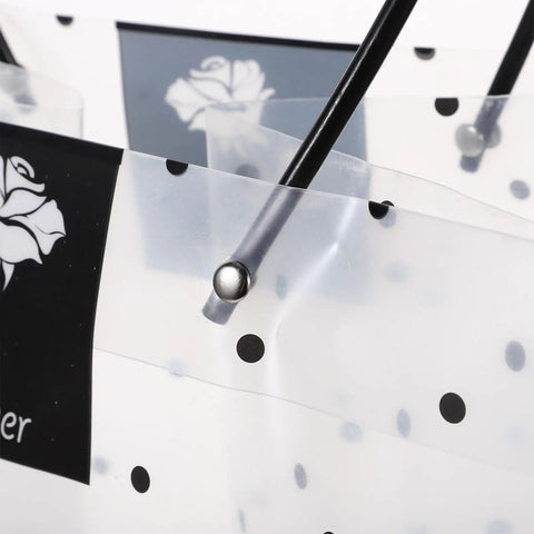 Close-up of clear plastic flower packaging bags with handle for bouquets, polka dot design, durable, for weddings and Valentine gifts.
