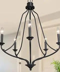 Black 5-Light Farmhouse Chandelier With Candle-Style Cups, Matte Iron Finish in a room, showcasing modern rustic design.